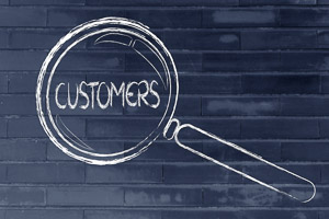 finding customers, magnifying glass focusing on clients